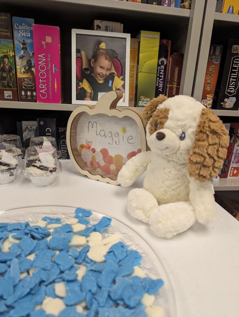 A tribute to Maggie set up at the Community Game Night on a table of treats.